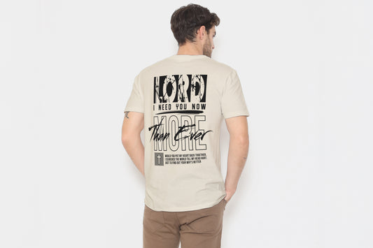 Man wearing a beige t-shirt with text on the back against a white background