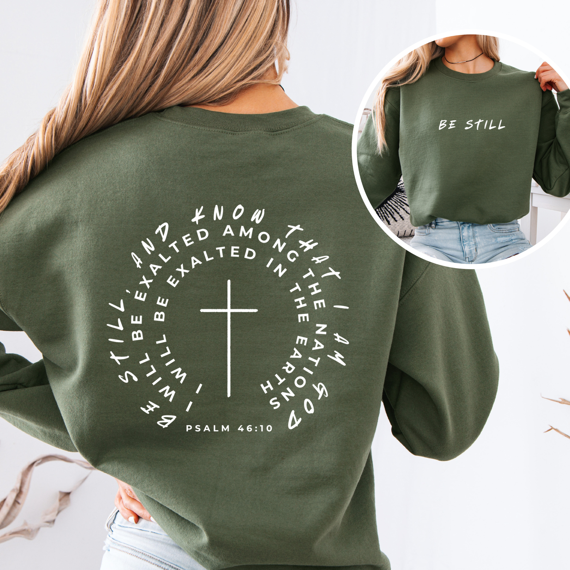 Green sweatshirt with text and cross design, worn by a person.